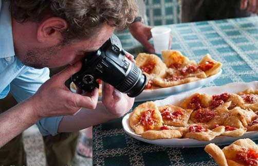 Picture of a man photographing food