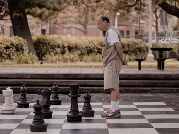 Man on giant chessboard
