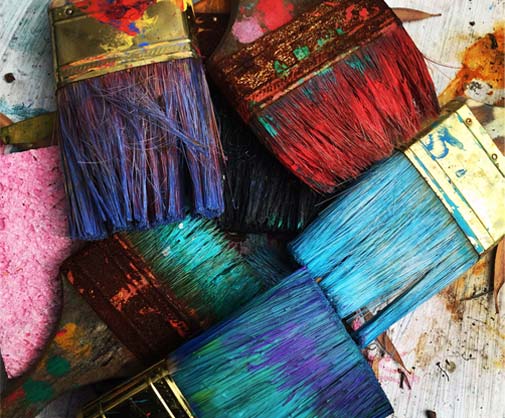 Supporting photo - colourful paint brushes