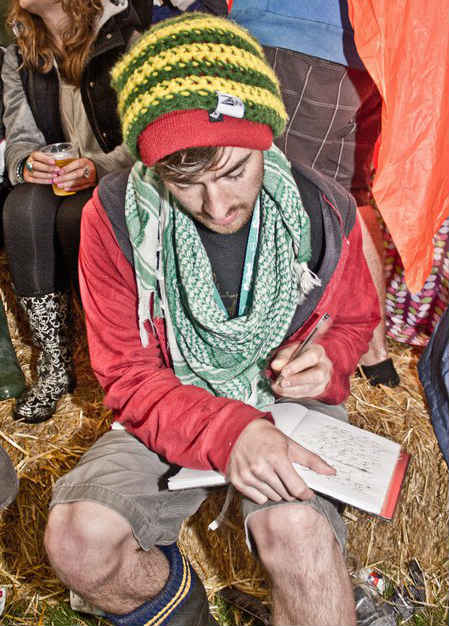 Tom writing at a festival